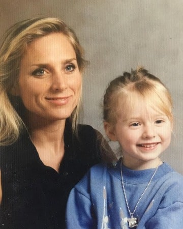 A smiling Childhood picture of Najarra Townsend with her mother in a light blue dress
